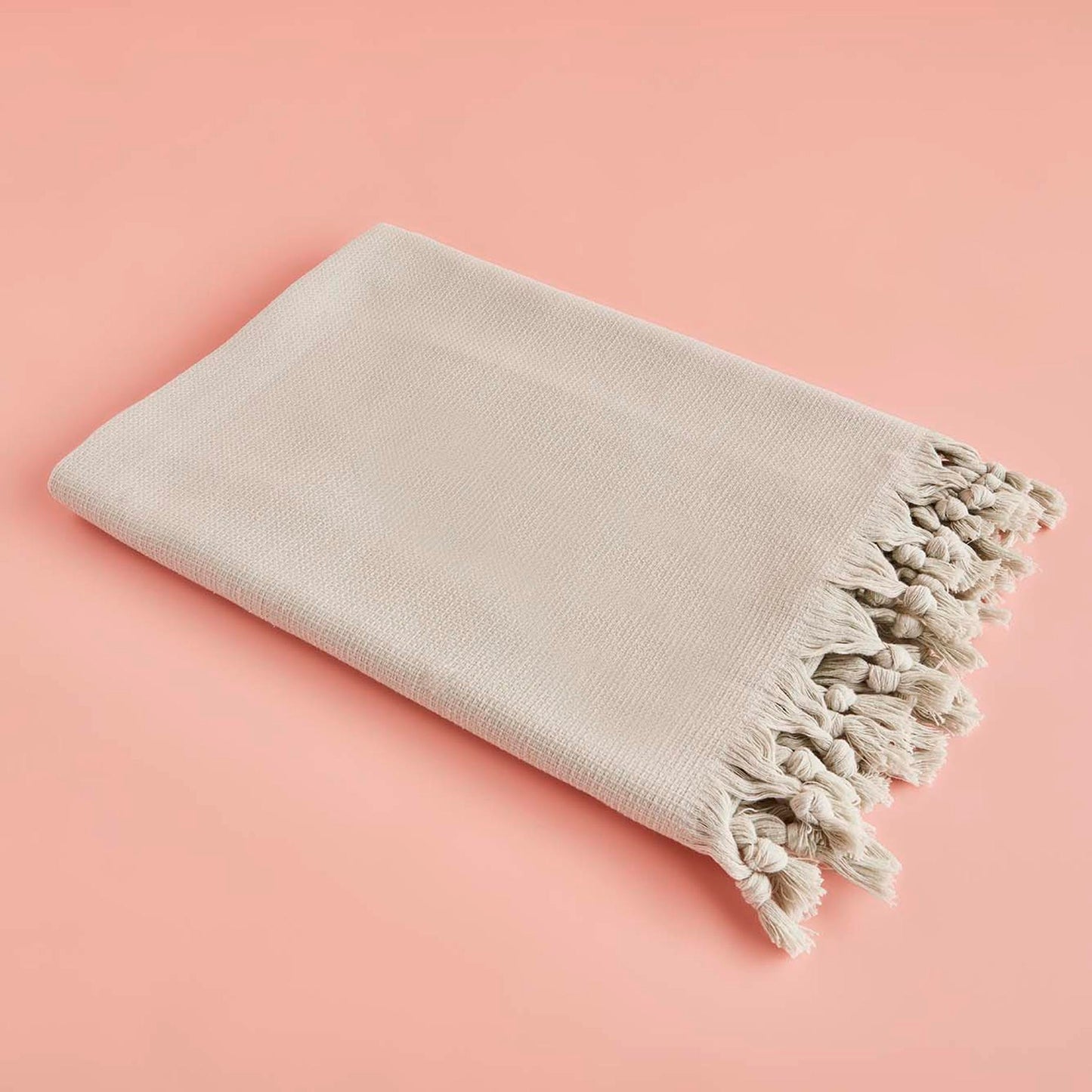 Light green throw blanket with soft and cozy texture.