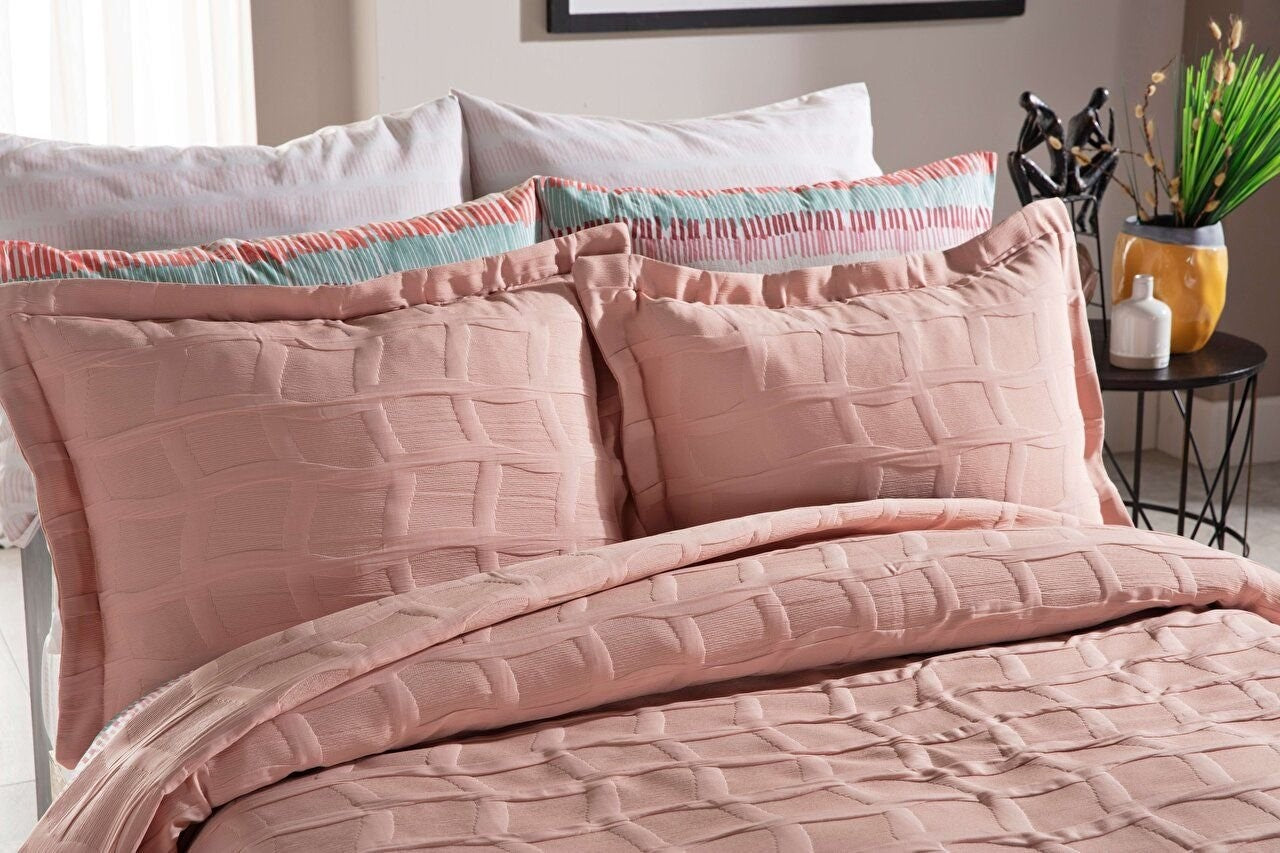 Pink bedspread set in king size, including a bed cover and two pillowcases.