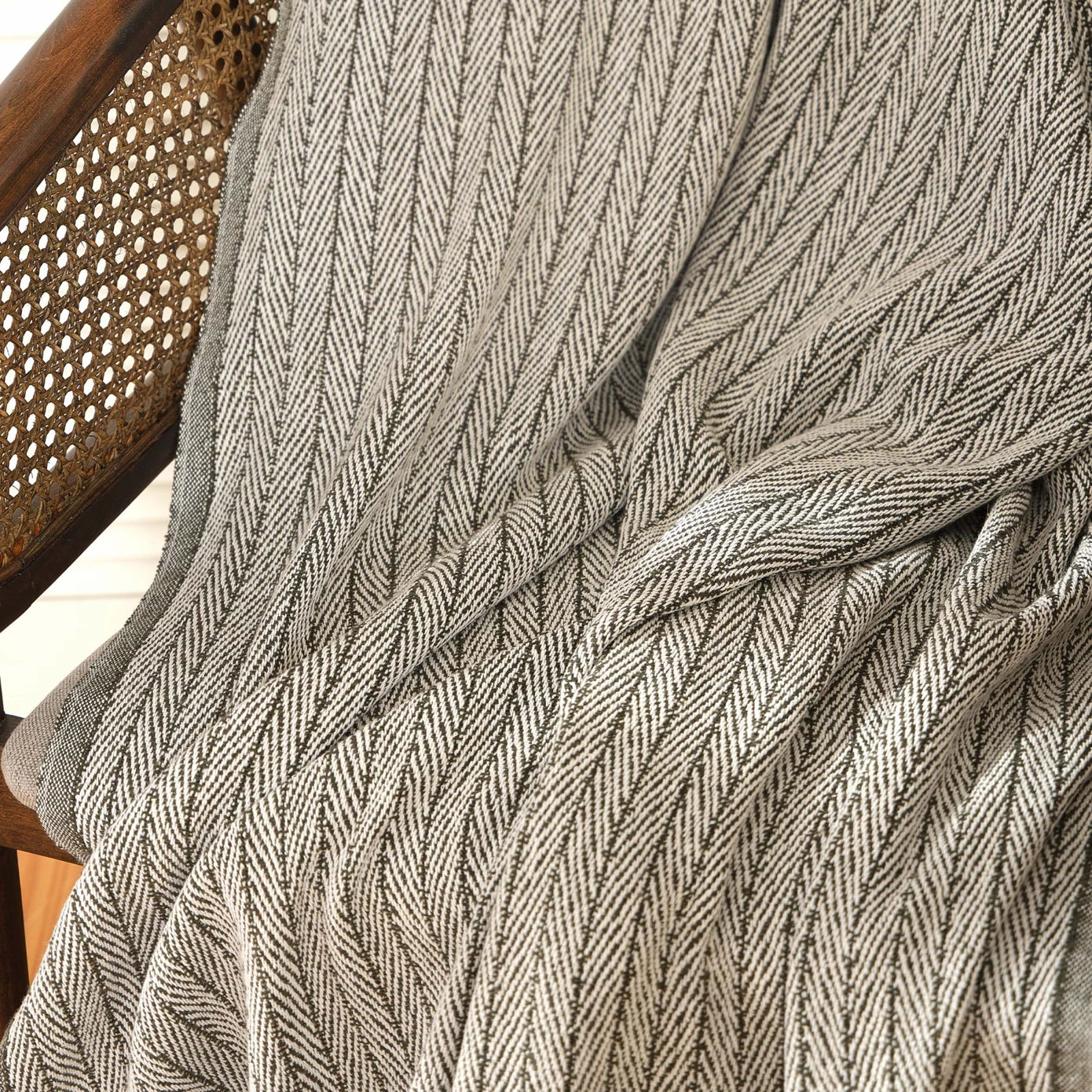 Green throw blanket with soft and cozy texture.