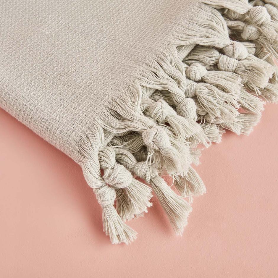 Light green throw blanket with soft and cozy texture.