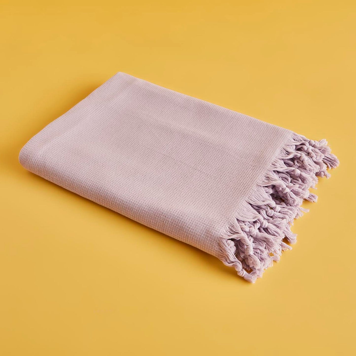 Lilac throw blanket with soft and cozy texture.