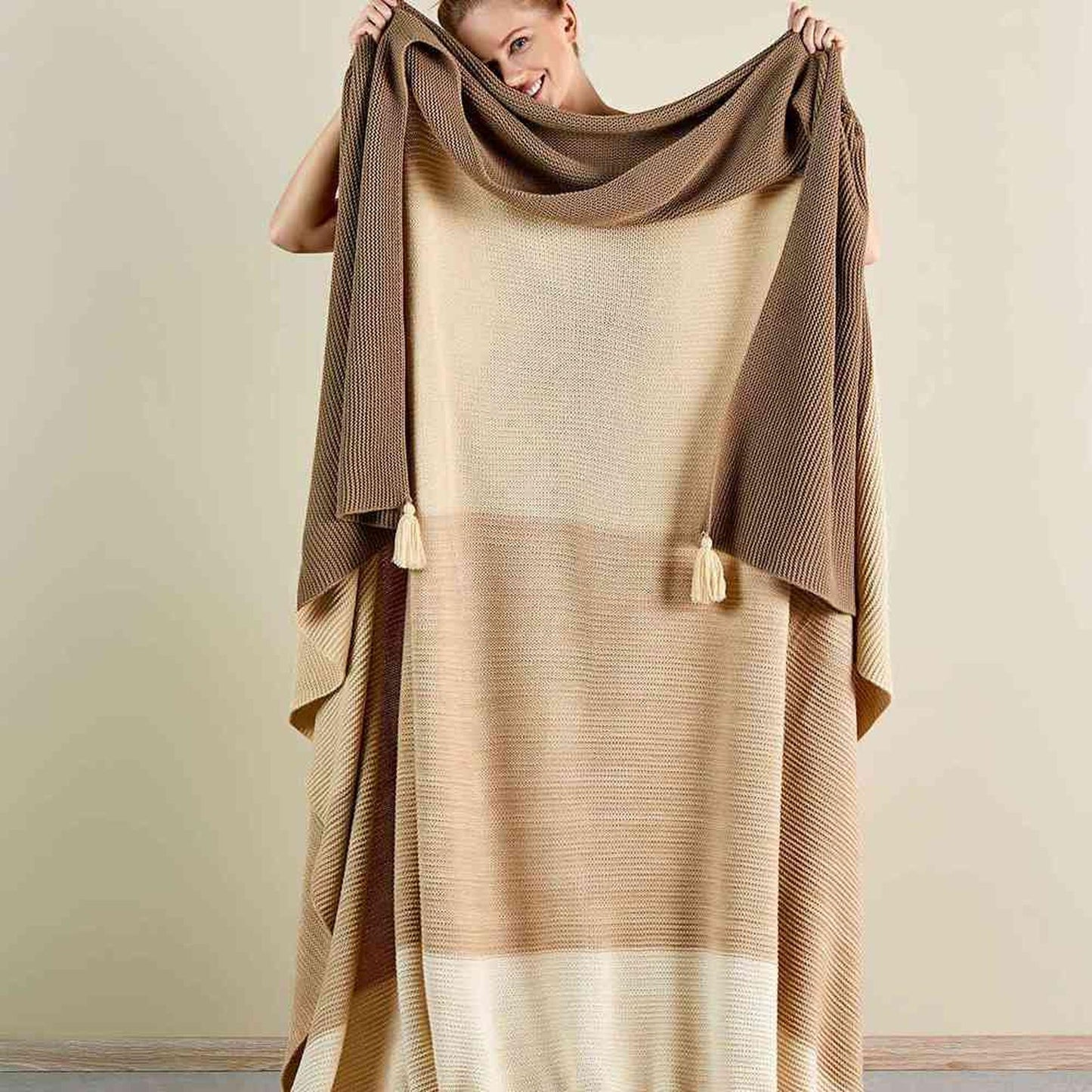 Beige bed blanket with soft and cozy texture in queen size.