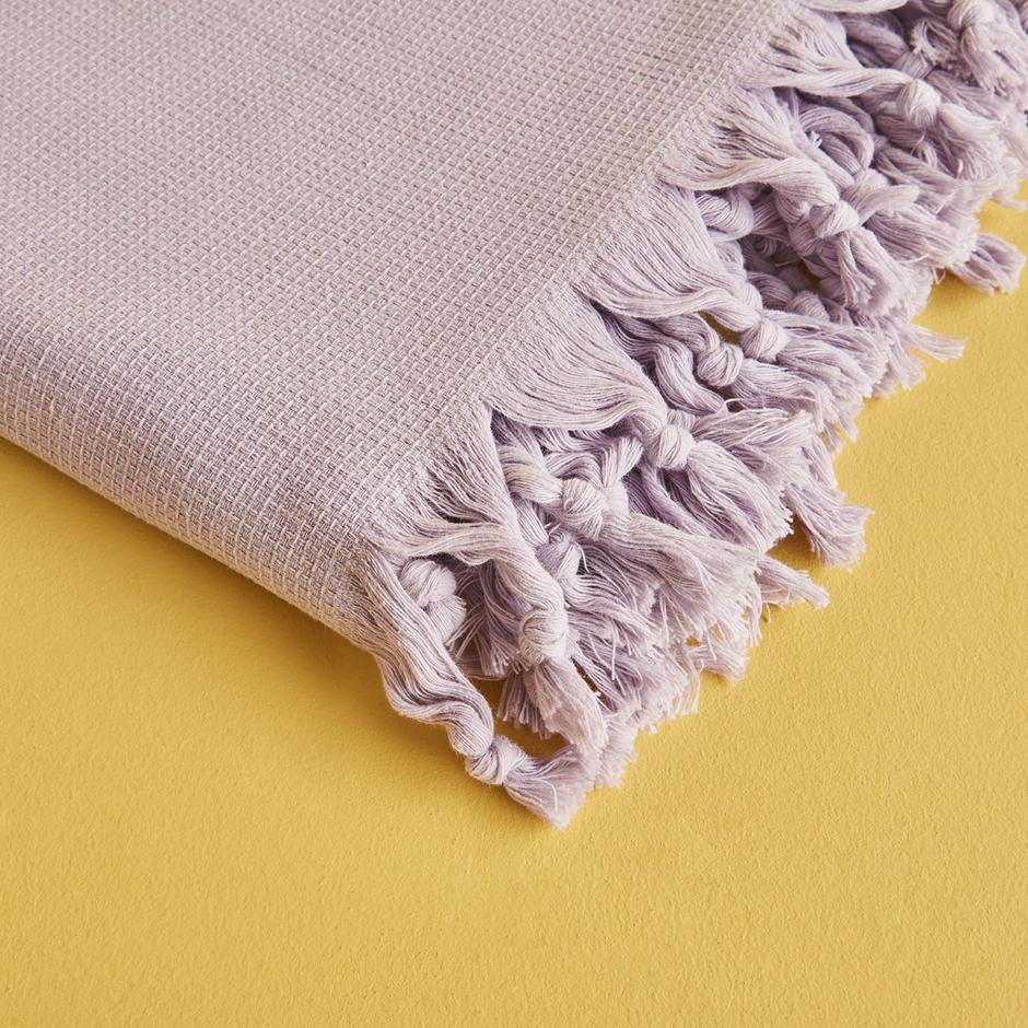 Lilac throw blanket with soft and cozy texture.