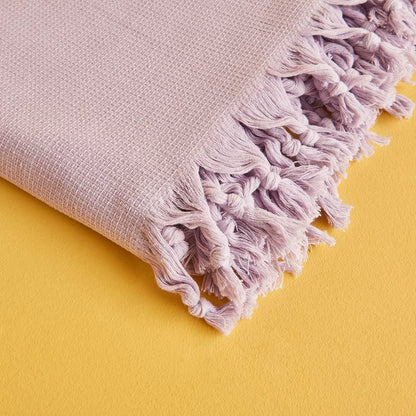 Lilac throw blanket with soft and cozy texture.