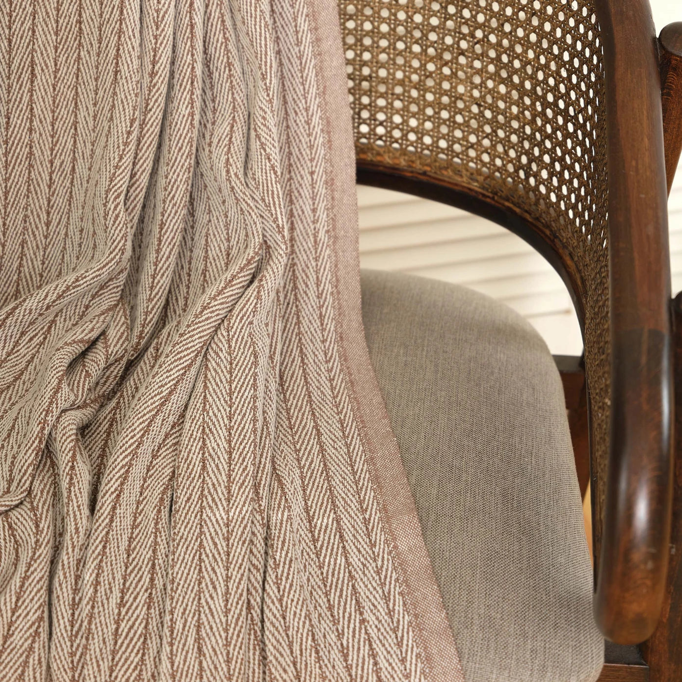 Brown throw blanket with soft and cozy texture.