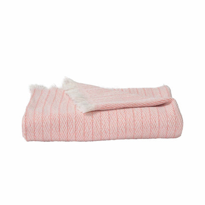 Pink throw blanket with soft and cozy texture.