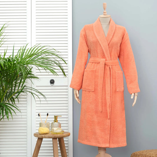 Salmon-colored bathrobe made from 100% cotton, offering comfort and style.