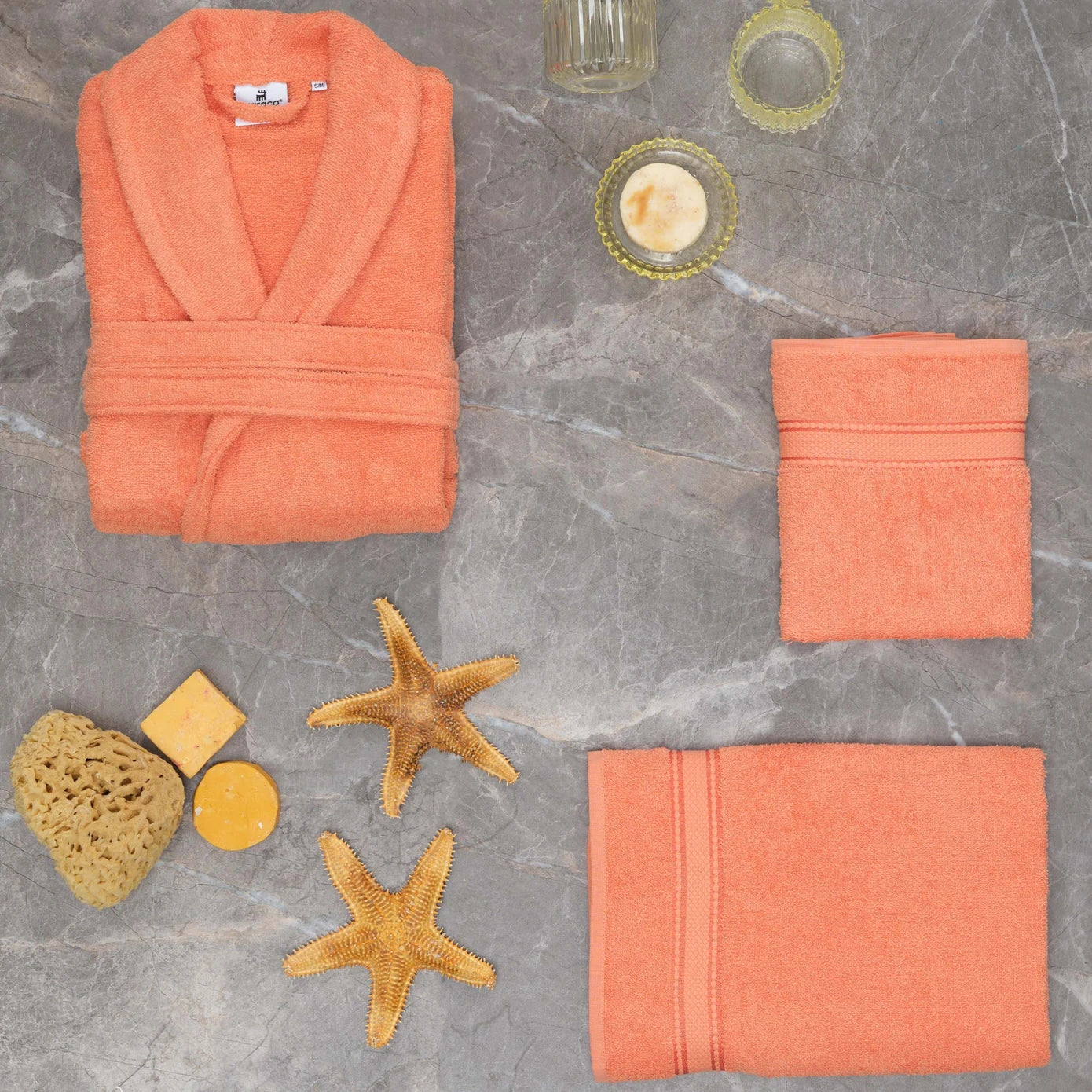 Salmon-colored bathrobe made from 100% cotton, offering comfort and style.