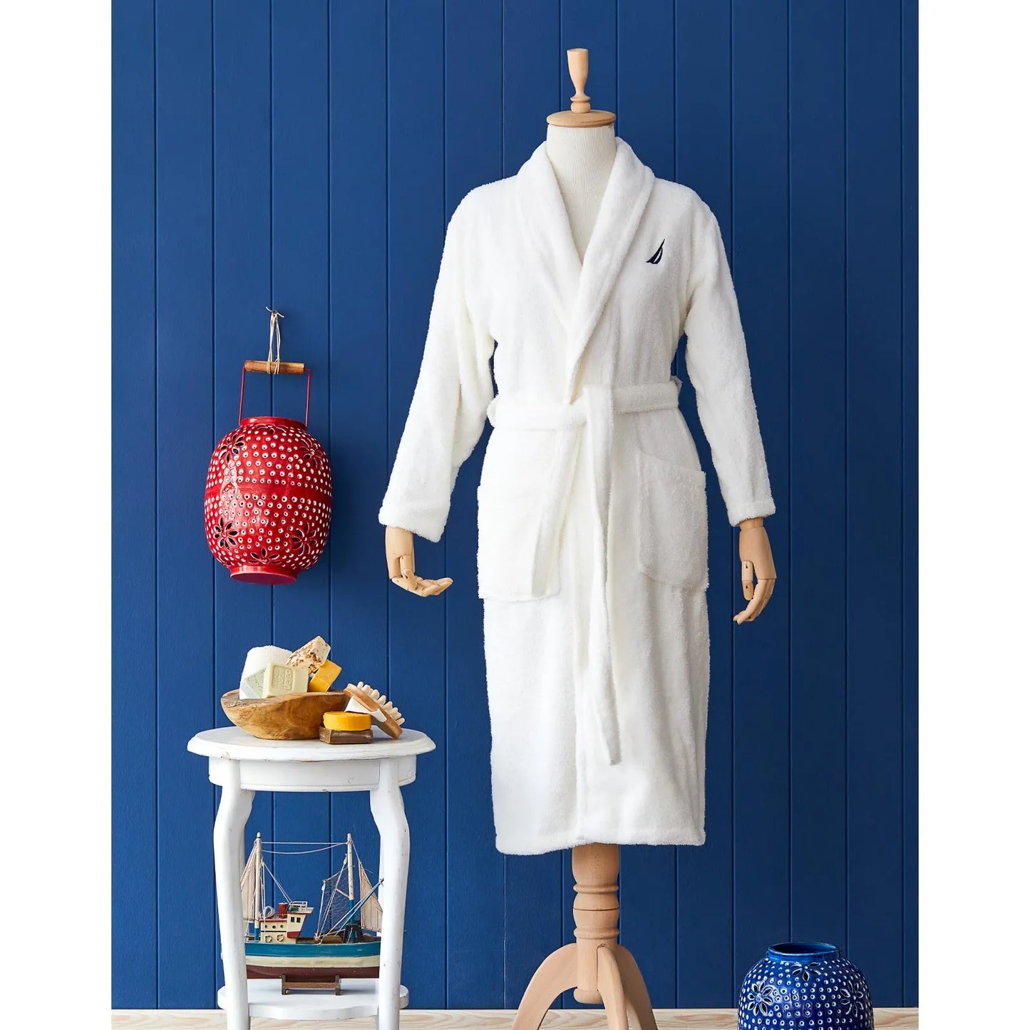 White bathrobe made from 100% cotton, providing a soft and comfortable experience.