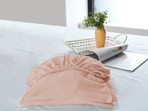 Light pink fitted bottom sheet, providing a snug and stylish fit for your bed.